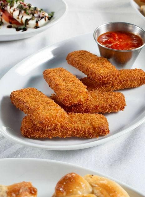 A plate of breaded chicken on top of a table.