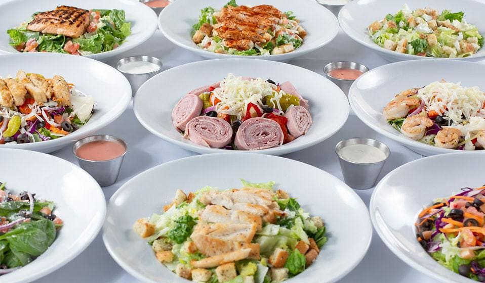 A table with many plates of food on it